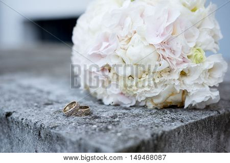wedding details of a ring white bouquet