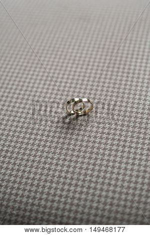 wedding details of a ring on a checkered chair