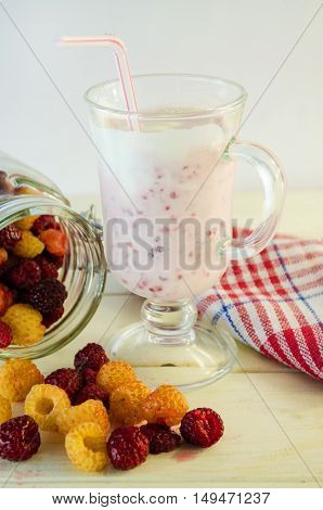 milkshake with berries fresh raspberries on a white background