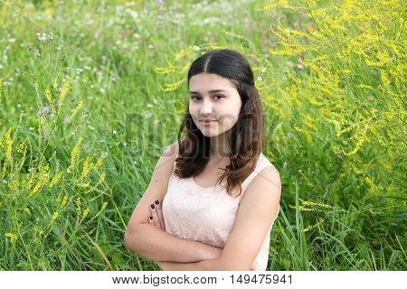 Girl in guipure dress resting on the meadow