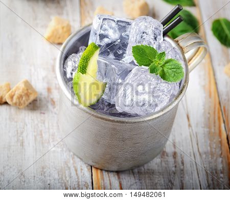 cold mojito in the vintage mug, lime, mint, ice and brown sugar