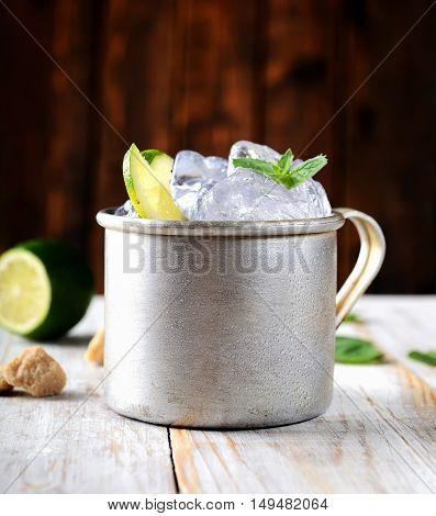 cold mojito in the vintage mug, lime, mint, ice and brown sugar