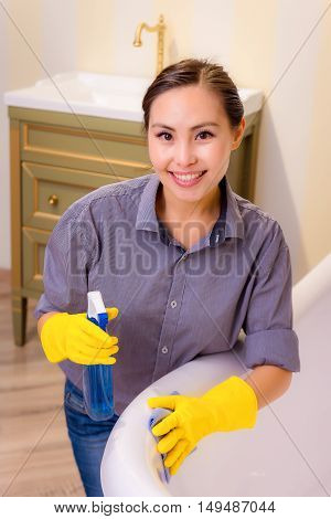 Young beautiful asian woman housekeeping in the bathroom
