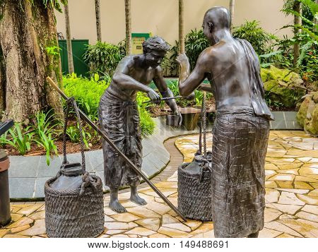 SINGAPORE, REPUBLIC OF SINGAPORE - JANUARY 09, 2014: Sculptures of Indian milk traders in the Telok Ayer area, Singapore