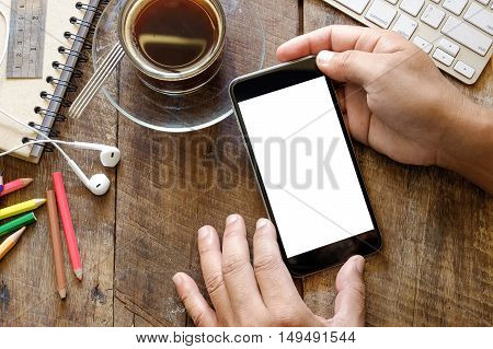 Smart phone with white blank empty screen on wood desk table in home office.