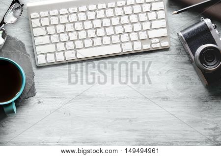 office table with notebook computer keyboard and coffee mug. Copy space.