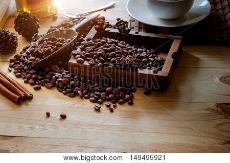 Cup of coffee beans and scoop on old rusty background