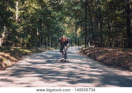 Longboard Skating - Skateboarder Ride A Longboard Through The Forest