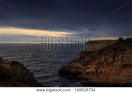 Landscape of sandstone and carbonate rock cliffs against the ocean