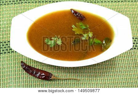 Rasam is a traditional indian soup made out of curry powder and lentil. It is eaten with rice as part of the Indian lunch.