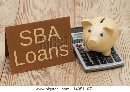 Getting a SBA Loan A golden piggy bank card and calculator on a wood background with text SBA Loans