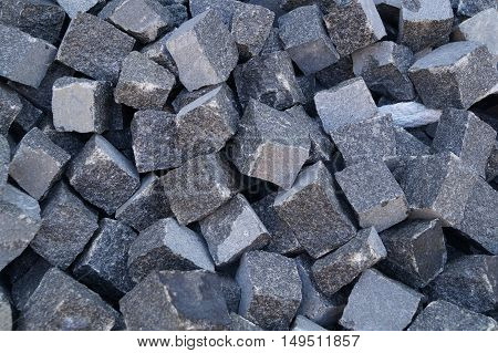 Pile of grey cube granite stones, texture