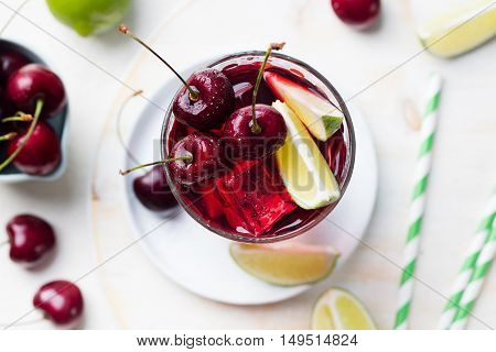 Cherry Limeade, lemonade, cola, cocktail in a tall glass on a white background Top view Copy space