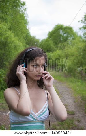 Girl in the forest is in talks with the microphone