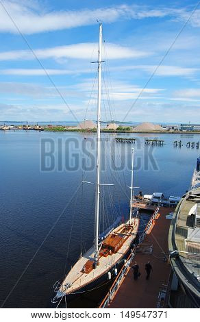 Edinburgh, United Kingdom - June 16, 2014. The 1930s racing yacht Bloodhound which was owned by the Queen in the 1960s is now moored alongside Royal Yacht Britannia in Edinburgh, with people.