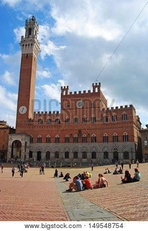 Siena, Italy - October 8, 2014. Palazzo Comunale on Piazza del Campo square in Siena, with people.