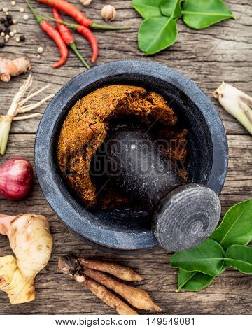 Assortment Of Thai Food Cooking Ingredients And Paste Of Thai Popular Food Red Curry  With Mortar An