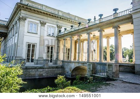 WARSAW POLAND - SEPTEMBER 27: Little bridge with columned gallery on the Lazienki canal near the Lazienki Palace the Palace on the Water in Royal Baths Park Lazienki Park in Warsaw Poland on September 27 2016