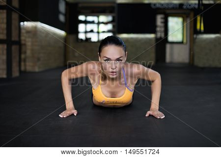 Woman pushed from the floor in the gym. Concept workout healthy lifestyle sport