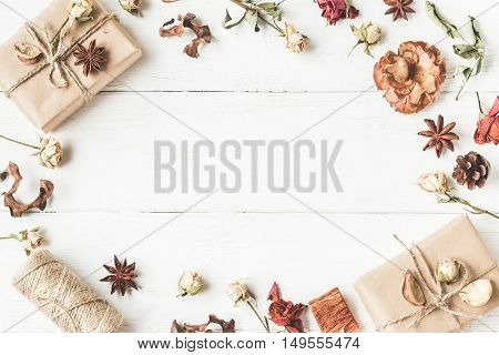 Autumn composition. Frame with gift paper bags autumn leaves anise stars dried flowers. Workspace. Top view flat lay