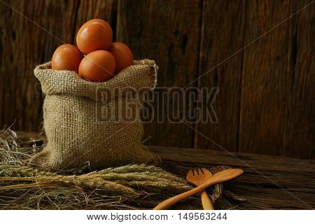 Fresh eggs on wooden background from farm and prepare for cook in kitchen room, Organic food and clean food for healthy, Eggs from farm to the market for raw material to cooking by chef in restaurant.