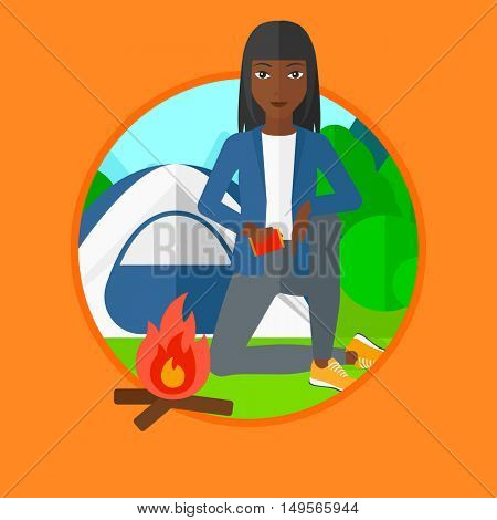 An african-american young woman kindling campfire on the background of camping site with tent. Tourist relaxing near campfire. Vector flat design illustration in the circle isolated on background.