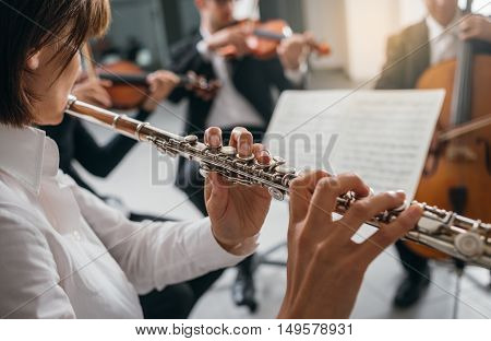 Flutist Playing Her Instrument On Stage