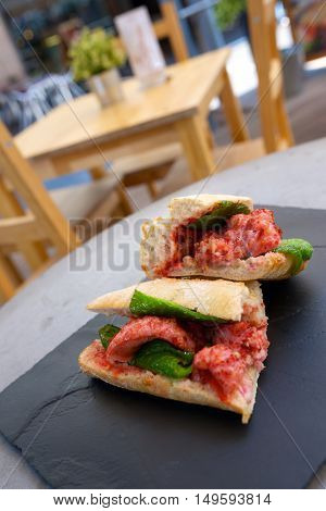 Sausage butty with green pepper and tomato.