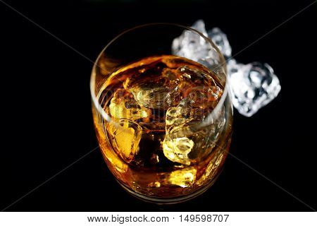 whiskey and ice on a black background