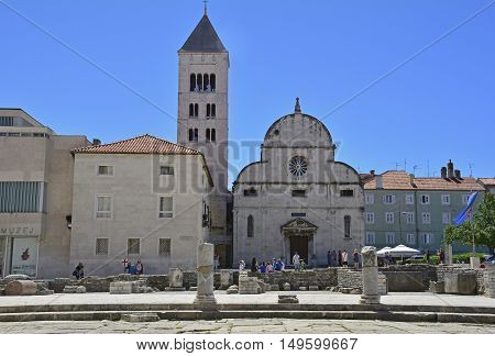Zadar Croatia - June 18th 2016. Tourists walk around the Roman Forum and other historic buildings in the Croatian city of Zadar.