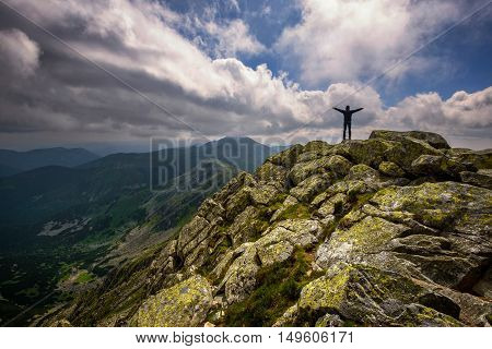 Mountain landscape and self portrait from hill Chopok in Low Tatras at Slovakia. Dramatic cloudy sky during summer day at mountain peak.