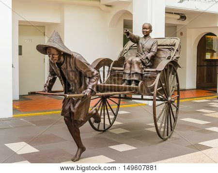 SINGAPORE, REPUBLIC OF SINGAPORE - JANUARY 09, 2014: Sculptures of Chinese rickshaw in the Telok Ayer area, Singapore