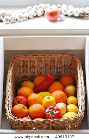 knitted basket with fruit and vegetables, vertical
