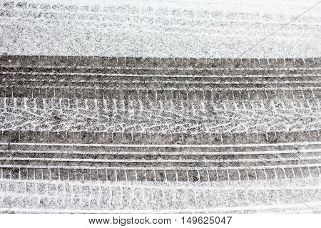 Wheel tracks on the winter road covered with snow.