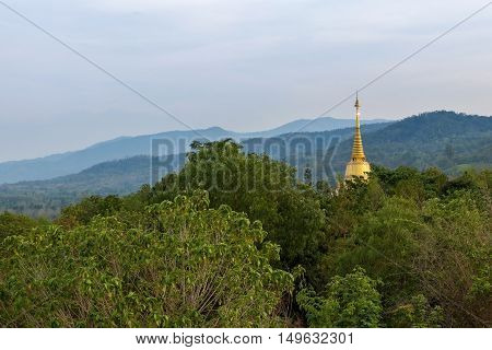 Top Of The Golden Pagoda View In Natural Environment On A Hilltop In A Forest At Twilight Time. Tip