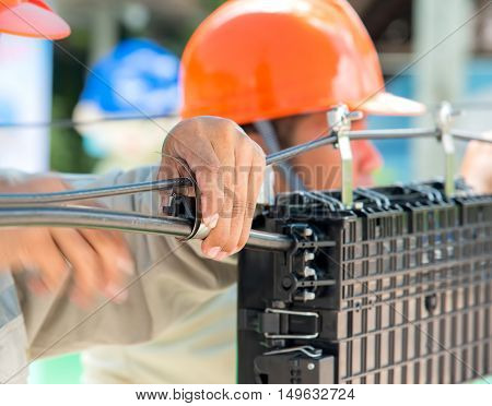 Technicians are install cabinet on fiber optic cable.