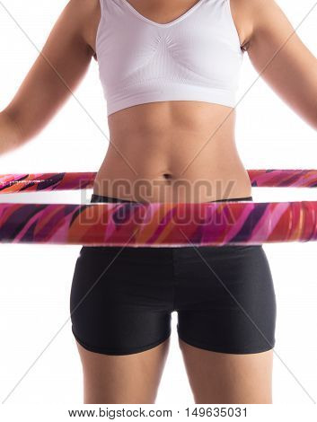 Woman working out with hoola hoop daily excercise at home
