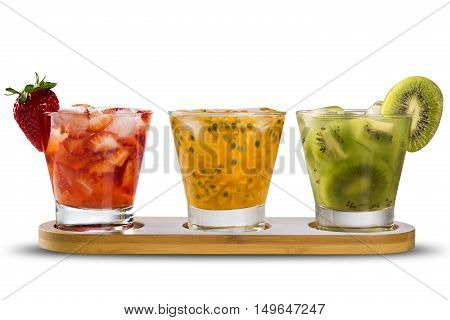 Three Drinks Made With Passion Fruit, Strawberry And Kiwi Caipirinha On White Background