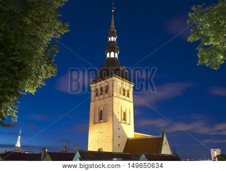 The spire of old Niguliste Church closeup on a summer night. Old Tallinn