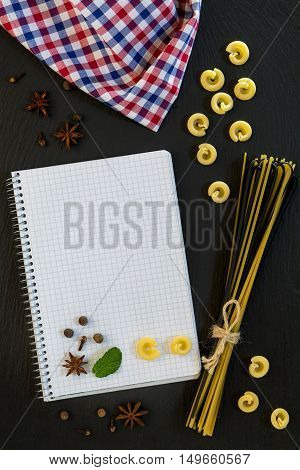 Blank Cookbook With Conventional And Black Uncooked Italian Pasta