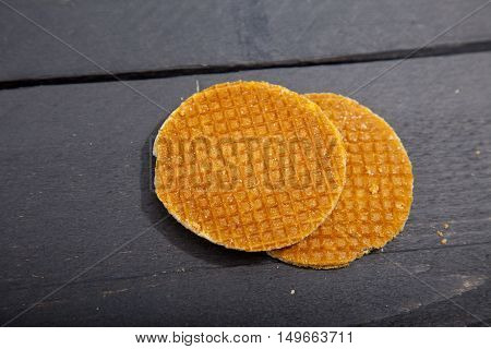 Dutch cookie stroopwafels on black wooden background