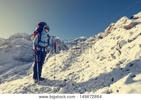 Happy trekker resting on her ascend. Thoron La pass at 5416m in Nepal.