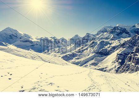 Snow covered path across mountain landscape. Thorong La pass at 5416 m in Nepal.