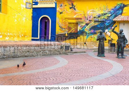 CARTAGENA COLOMBIA - MAY 24: View of statues and a mural in Santisima Trinidad Plaza in Cartagena Colombia on May 24 2016