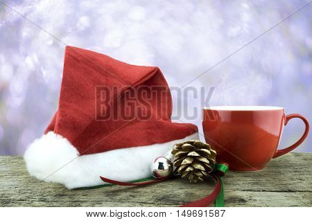 Santa Hat,red Cup Hot Drink ,pinecone And Christmas Decorate Staff On Woodden Table