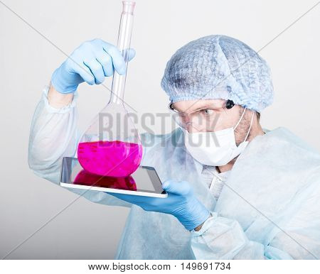 Funny crazy emotional chemist with flask. mad scientist in his laboratory experimenting on secret formulas