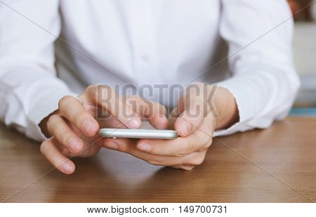 Close up of hands using smartphone in office