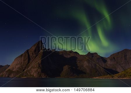 Northern lights over Olstind mountain Lofoten Norway