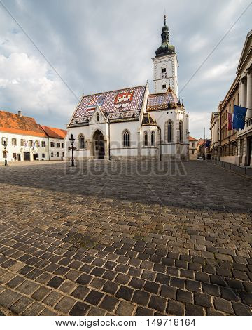ZAGREB CROATIA - 17TH AUGUST 2016: The outside of St Marks Church in central Zagreb Croatia during the day. A person can be seen.