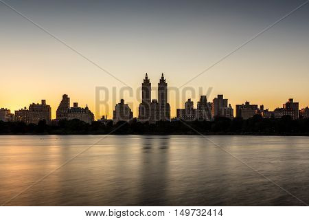 Upper West Side buildings and Central Park Jacqueline Kennedy Onassis Reservoir at sunset. Manhattan, New York City